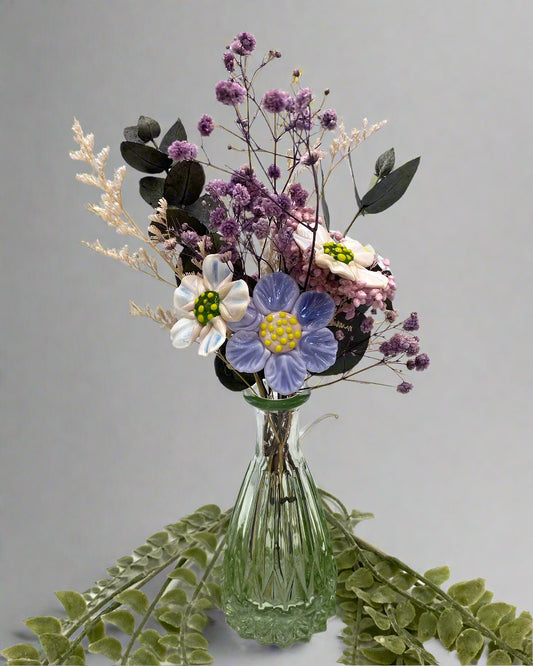 Bouquet of flowers in a clear glass vase on a white background